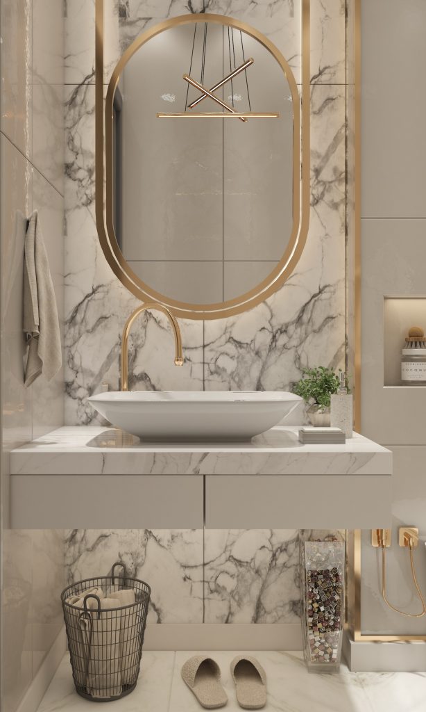 bathroom sink with gold accents and marble tiles